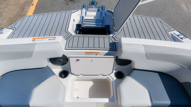 Slide: The Image of The image shows the stern of a Starcraft SVX 211 OB boat with gray upholstery and storage. - 15