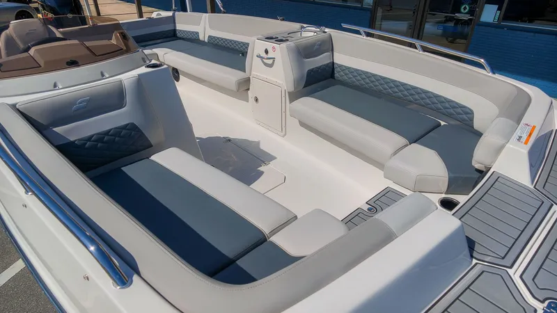 Slide: The Image of The image shows the spacious deck of a Starcraft SVX 211 OB boat with gray and blue seating. - 6