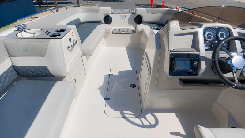 Slide: The Image of The image shows the cockpit of a Starcraft SVX 211 OB boat with modern instruments and comfortable seating. - 20