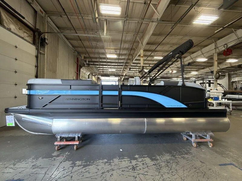 Slide: The Image of A Bennington 21 S Swingback pontoon boat is in a warehouse. - 5
