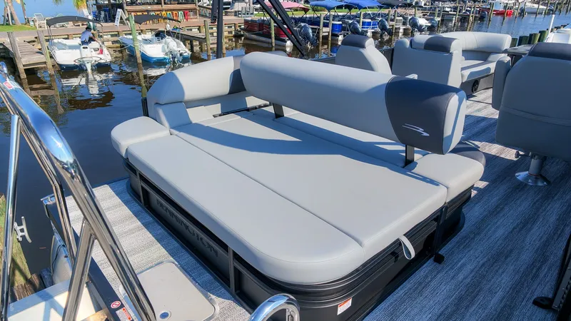 Slide: The Image of The image shows the stern of a Bennington 21 S Swingback pontoon boat with gray upholstery. - 7