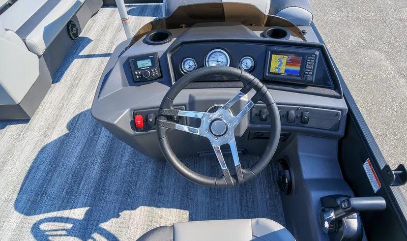 Slide: The Image of The image shows the helm of a 2027 Bennington 21 S Swingback boat with modern instruments. - 19