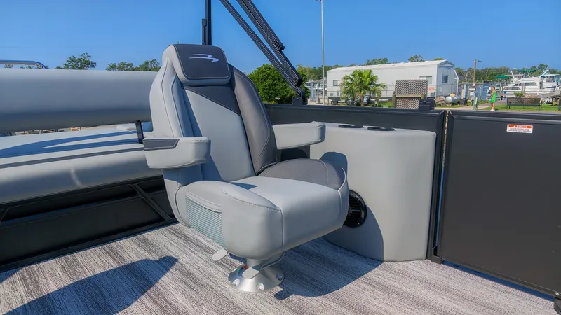 Slide: The Image of A luxurious gray captain's chair on a Bennington 21 S Swingback boat, surrounded by modern interior. - 12