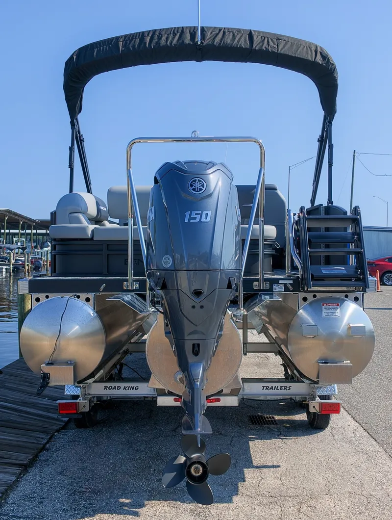 Slide: The Image of A 2027 Bennington 21 S Swingback with a 150 HP outboard motor, on a trailer at the dock. - 3