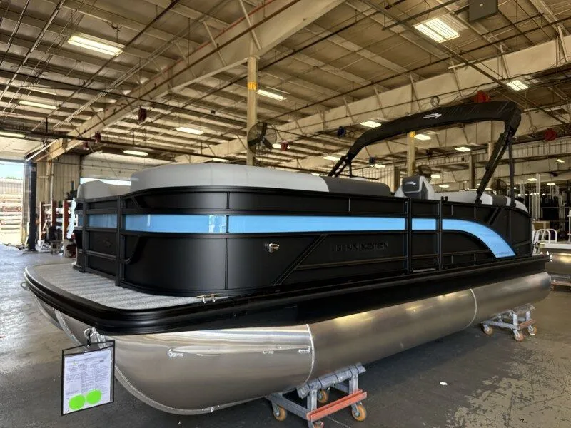 Slide: The Image of A Bennington 21 S Swingback pontoon boat in a warehouse. - 3
