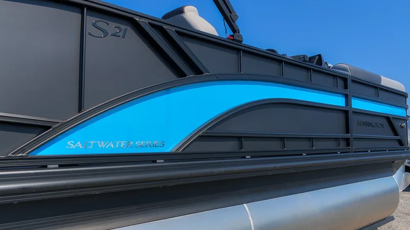 Slide: The Image of The image shows the side of a Bennington 21 S Swingback pontoon boat with a blue accent. - 20