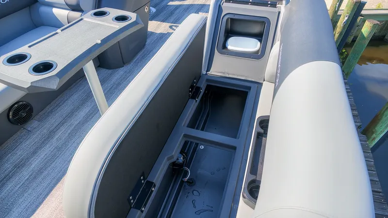 Slide: The Image of The image shows the interior of a 2027 Bennington 21 S Swingback with seating and storage space. - 14