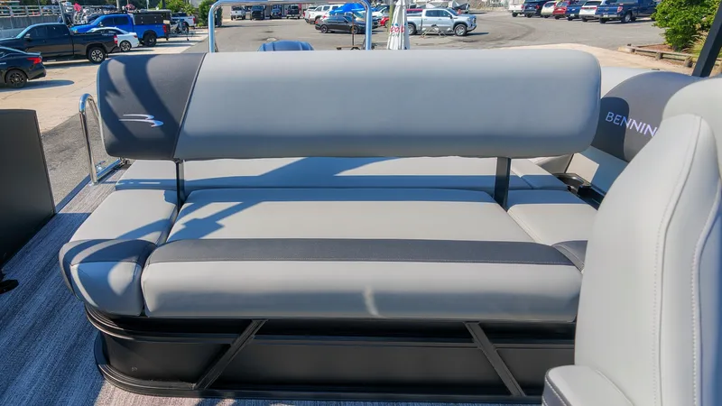 Slide: The Image of The image shows a gray bench seat on a Bennington 21 S Swingback pontoon boat. - 9
