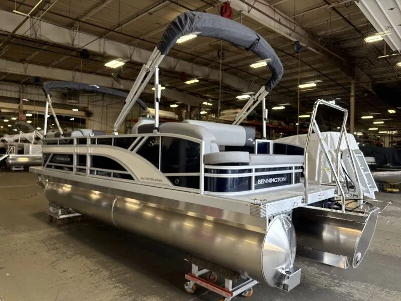 Slide: The Image of A Bennington 22 S Swingback pontoon boat is in a warehouse. - 2