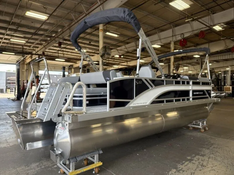 Slide: The Image of A Bennington 22 S Swingback pontoon boat is in a warehouse. It features a modern design. - 4