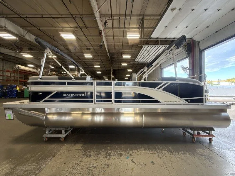 Slide: The Image of A Bennington 22 S Swingback pontoon boat is in a warehouse. It features a modern design. - 4