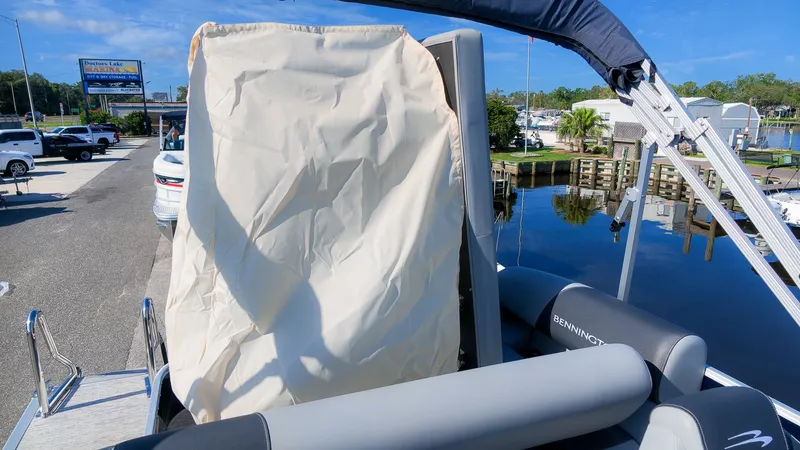 Slide: The Image of The image shows a Bennington 22 S Swingback pontoon boat with gray seats and a canopy. - 9