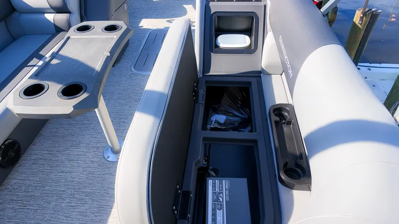 Slide: The Image of The image shows the interior of a 2027 Bennington 22 S Swingback with seating and storage. - 16