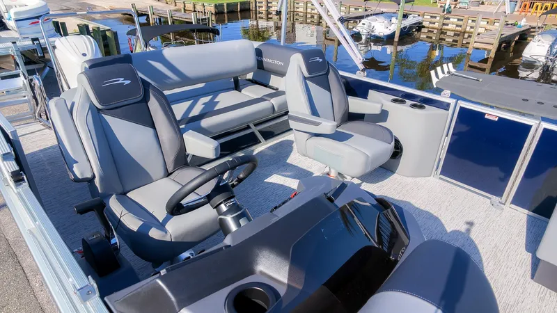 Slide: The Image of The image shows the cockpit of a 2027 Bennington 22 S Swingback with gray and black seating. - 10