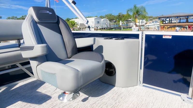 Slide: The Image of A modern boat seat with armrests and cup holders on a Bennington pontoon boat. - 13