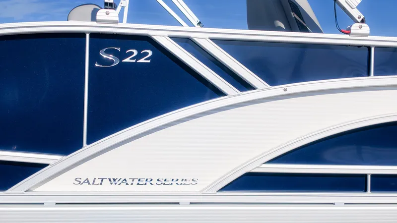Slide: The Image of Close-up of the blue and white side paneling on a Bennington 22 S Swingback boat. - 3