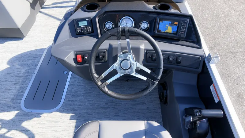 Slide: The Image of The image shows the helm of a 2027 Bennington 22 S Swingback with a steering wheel and instruments. - 18