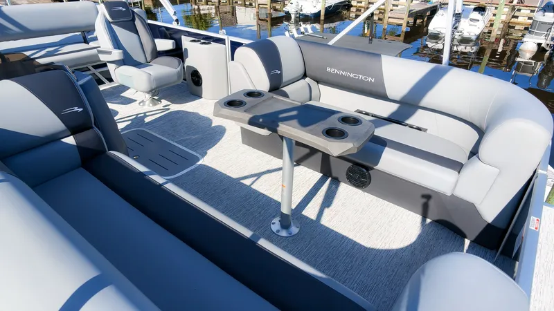 Slide: The Image of The image shows the interior of a 2027 Bennington 22 S Swingback with gray seating and a table. - 9
