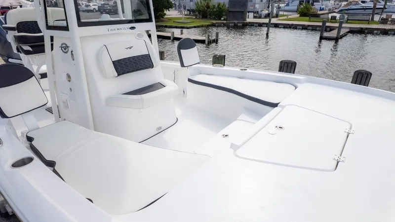 Slide: The Image of The image shows the deck of a Tidewater 2210 Carolina Bay boat at a dock. - 18