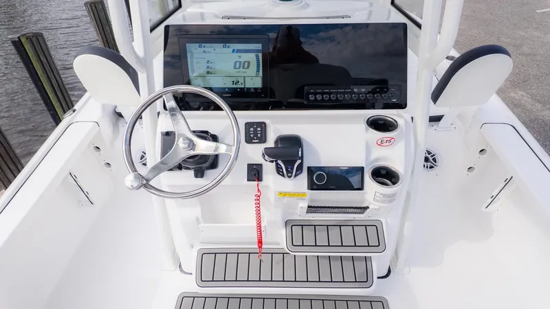 Slide: The Image of The image shows the helm of a 2026 Tidewater 2210 Carolina Bay boat. - 12