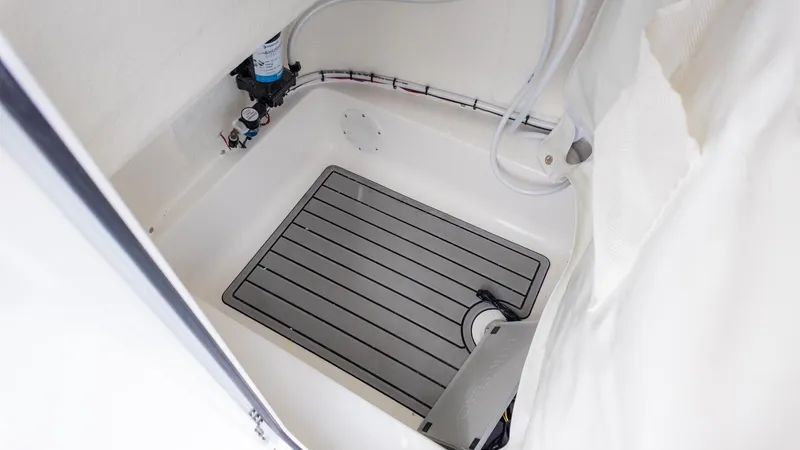 Slide: The Image of Interior view of a boat with a shower area and drain. - 18