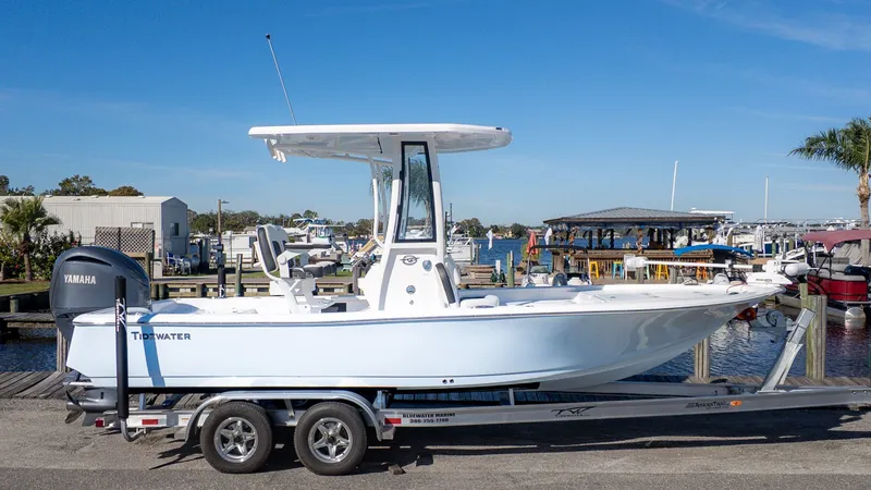 Slide: The Image of 2026 Tidewater 2210 Carolina Bay on a trailer, dockside with a clear blue sky. - 18