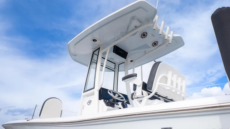 Slide: The Image of The image shows a modern boat with a white helm station and blue sky in the background. - 19