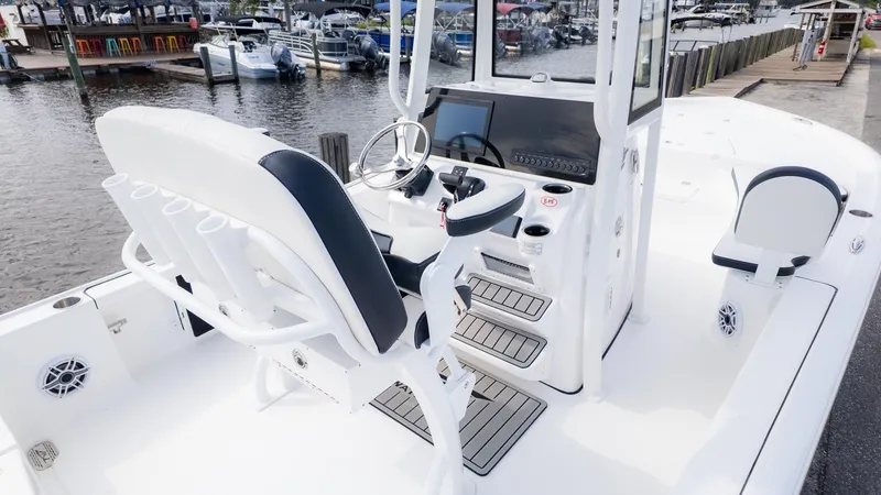 Slide: The Image of The image shows the cockpit of a Tidewater 2210 Carolina Bay boat at a marina. - 9