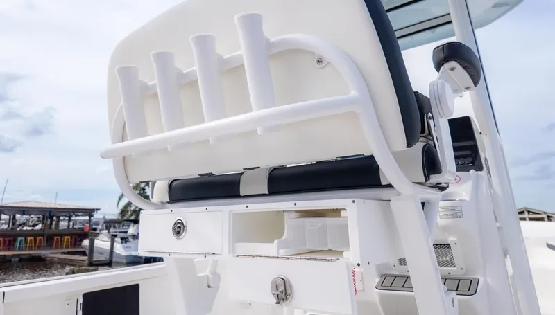Slide: The Image of The image shows the back of a boat seat with rod holders and storage. - 7