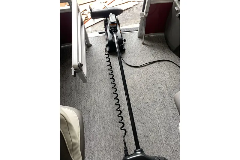 Slide: The Image of 2026 Sun Tracker Bass Buggy 18 DLX interior with trolling motor and carpeted flooring. - 5