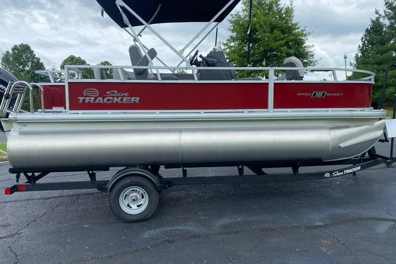 The Image of 2026 Sun Tracker Bass Buggy 18 DLX pontoon boat on trailer, parked outdoors. - 0