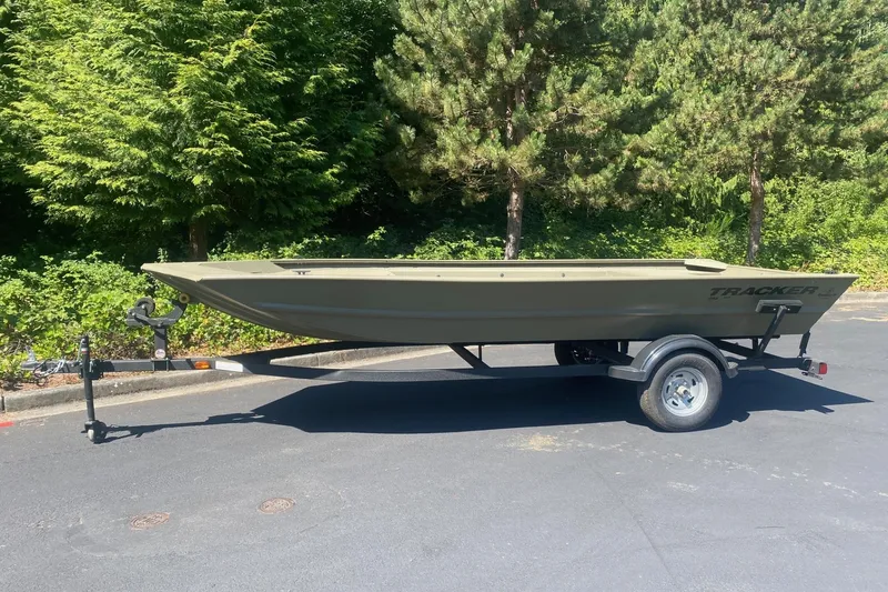 The Image of 2026 Tracker Grizzly 1754 Utility boat on trailer, parked outdoors. - 0