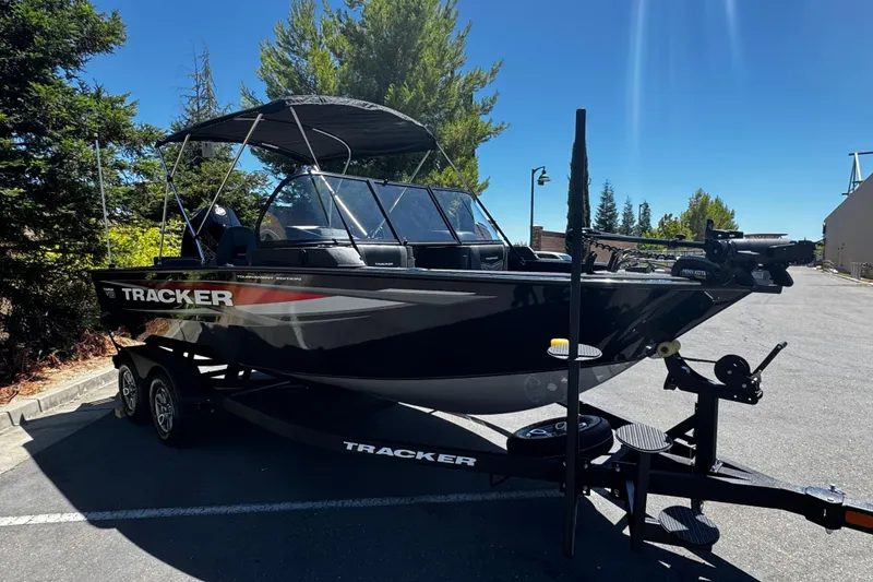 Slide: The Image of 2026 Tracker Targa V-19 Combo boat on trailer in sunny parking lot. - 3