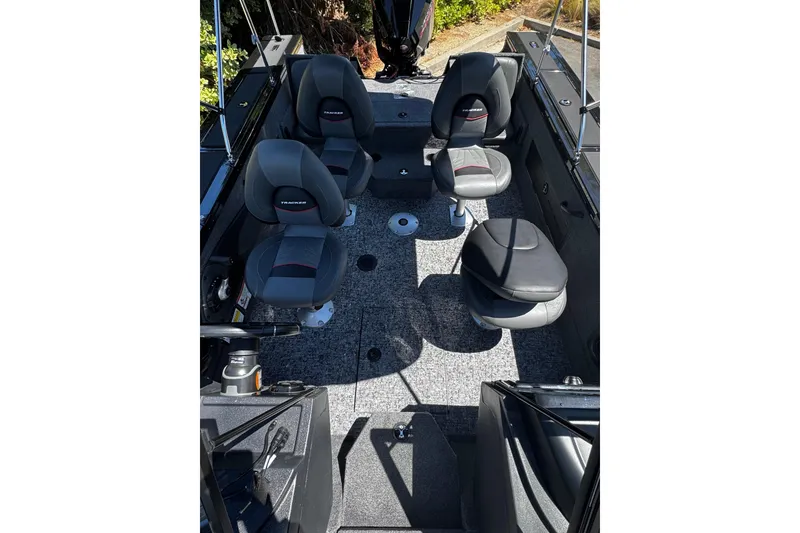 Slide: The Image of 2026 Tracker Targa V-19 Combo boat interior with four cushioned seats and carpeted flooring. - 5