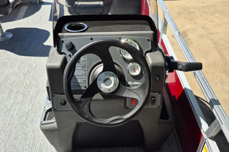 Slide: The Image of 2026 Sun Tracker Bass Buggy 18 DLX steering console with gauges and controls. - 9