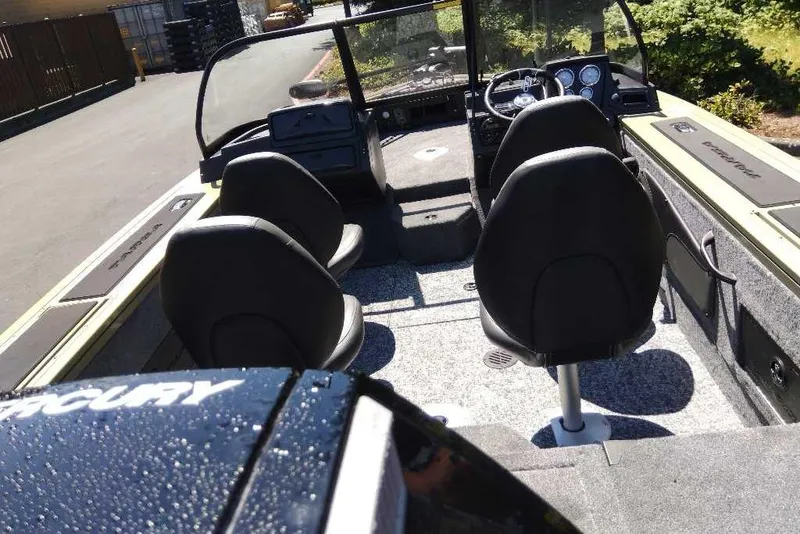 Slide: The Image of 2026 Tracker Targa V-18 Combo boat interior with seating and dashboard view. - 75