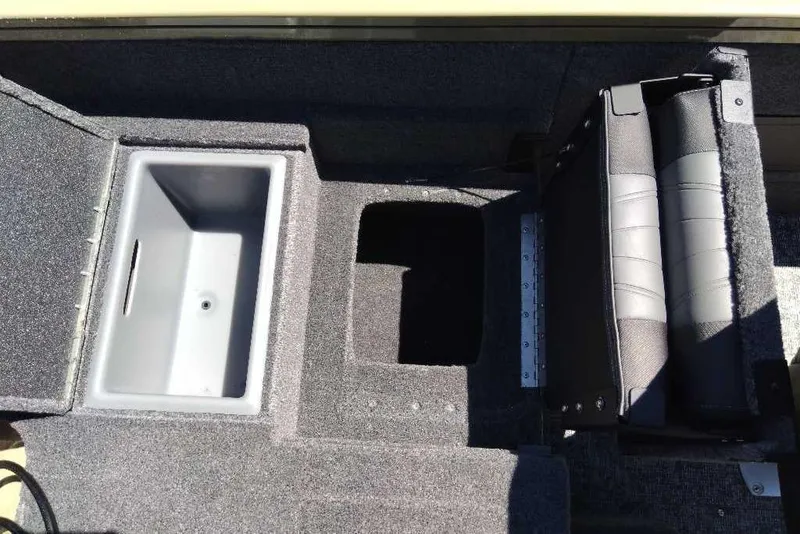 Slide: The Image of 2026 Tracker Targa V-18 Combo boat interior with storage compartments and seating. - 74