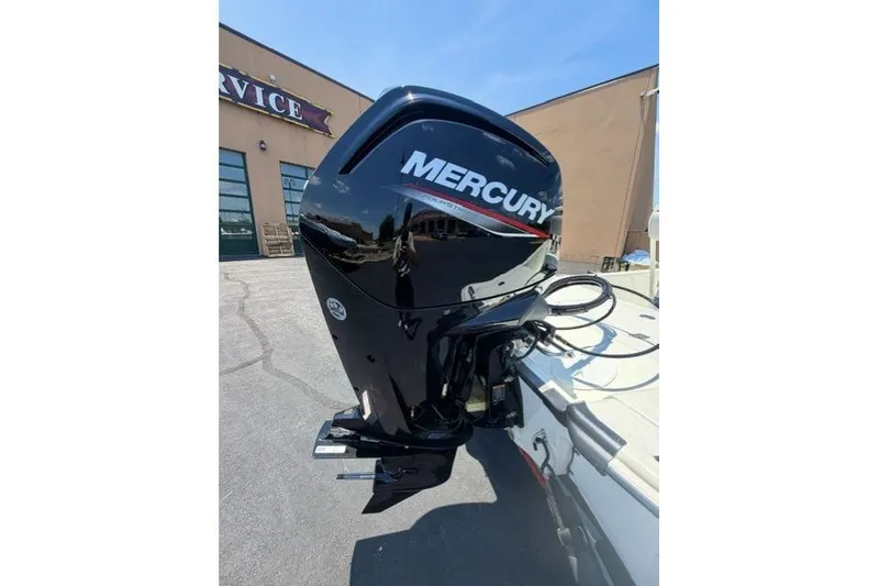 Slide: The Image of 2026 Mako Pro Skiff 17 CC with Mercury outboard motor in a sunny outdoor setting. - 4