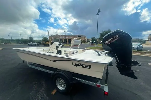 Slide: The Image of 2026 Mako Pro Skiff 17 CC boat with Mercury engine on trailer under cloudy sky. - 3