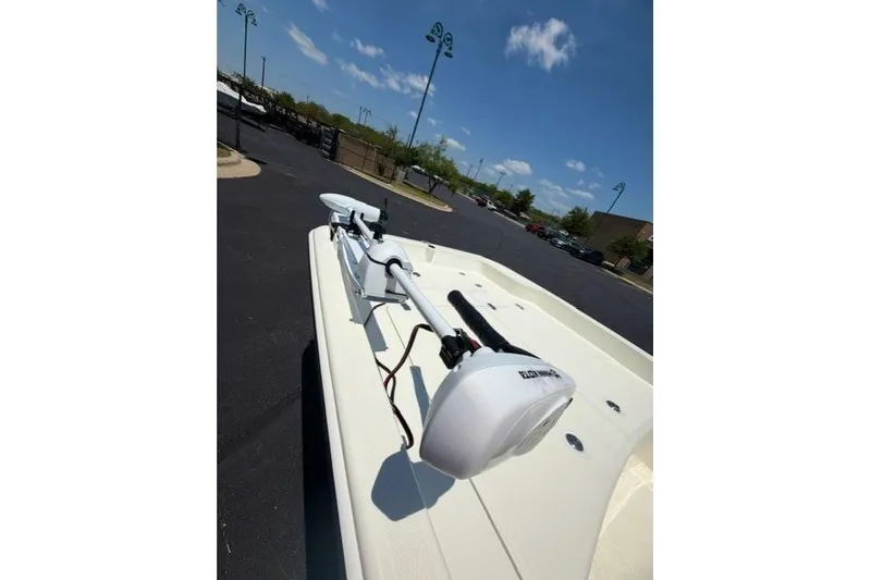 Slide: The Image of 2026 Mako Pro Skiff 17 CC boat with trolling motor on a sunny day. - 9