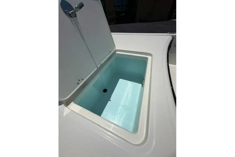 Slide: The Image of Open storage compartment on 2026 Mako Pro Skiff 17 CC boat. - 6