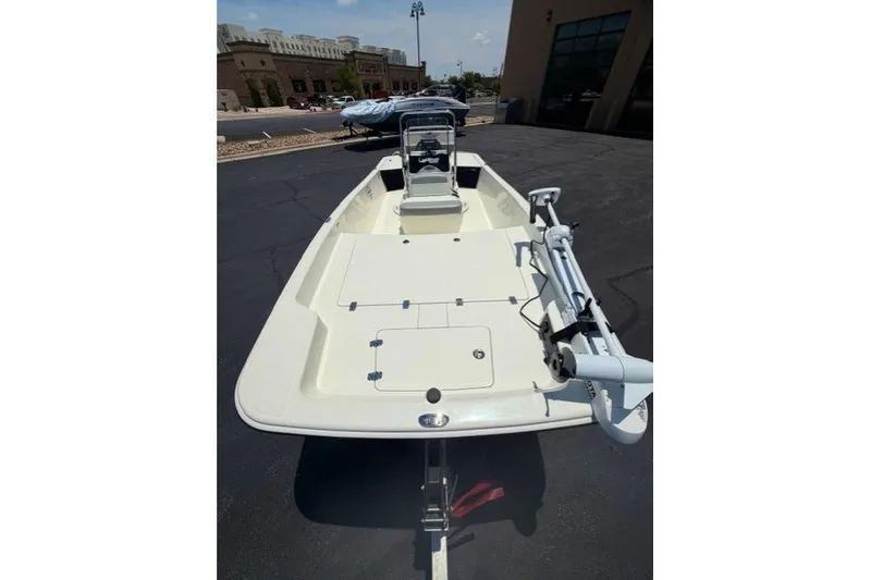 Slide: The Image of 2026 Mako Pro Skiff 17 CC boat on display in a parking lot. - 5