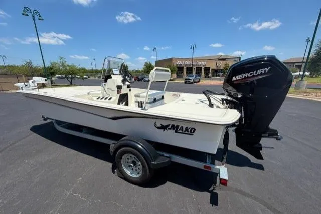 The Image of 2026 Mako Pro Skiff 17 CC boat with Mercury engine on trailer, parked outdoors. - 0