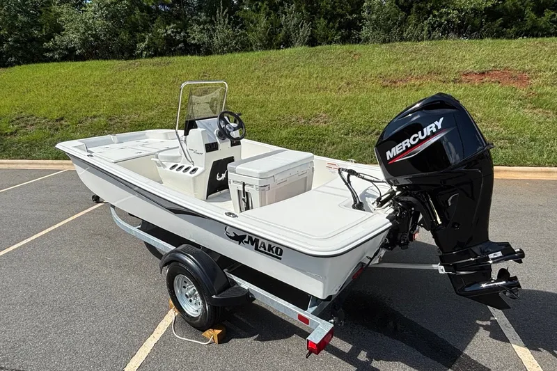 Slide: The Image of 2026 Mako Pro Skiff 15 CC boat with Mercury engine on trailer. - 5