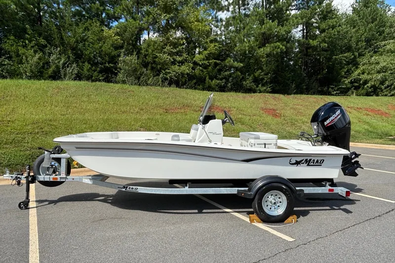 The Image of 2026 Mako Pro Skiff 15 CC boat on trailer, parked outdoors. - 0
