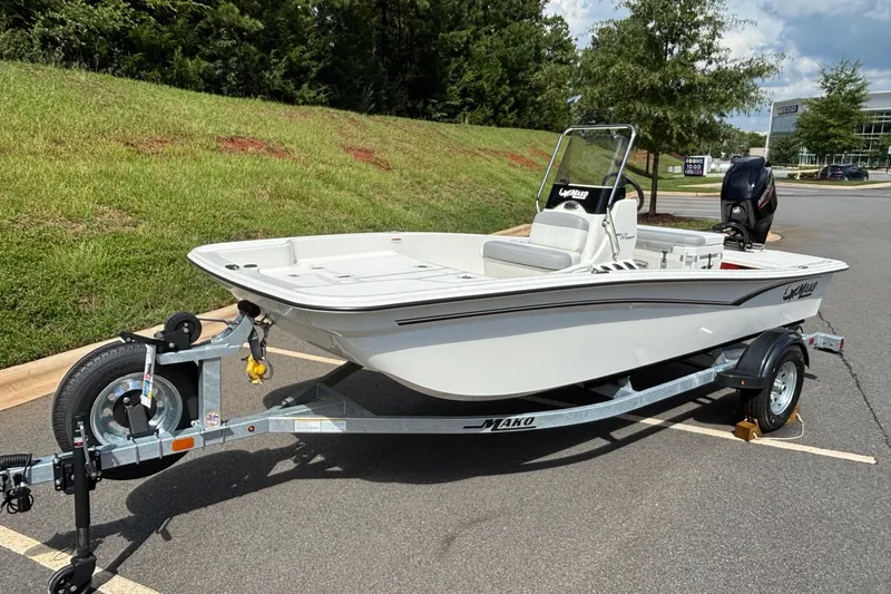 Slide: The Image of 2026 Mako Pro Skiff 15 CC boat on trailer in parking lot. - 2