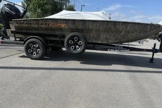 The Image of 2026 Tracker Grizzly 1756 T Marsh boat on trailer, parked outdoors. - 0