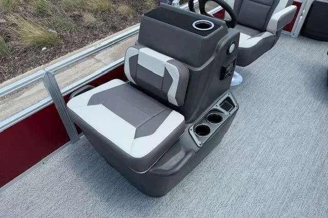 Slide: The Image of 2026 Sun Tracker Bass Buggy 18 DLX boat interior with gray seating and cup holders. - 16