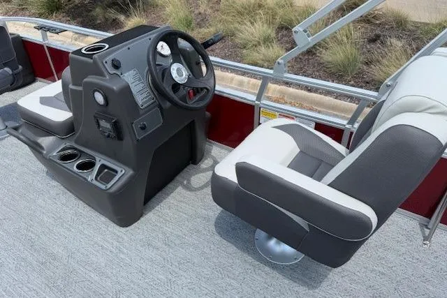 Slide: The Image of 2026 Sun Tracker Bass Buggy 18 DLX pontoon boat interior with steering console and seating. - 14