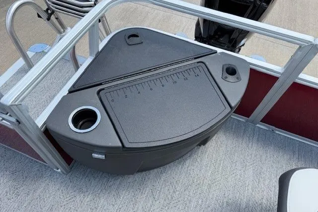 Slide: The Image of 2026 Sun Tracker Bass Buggy 18 DLX fishing station with measuring board and cup holder. - 9